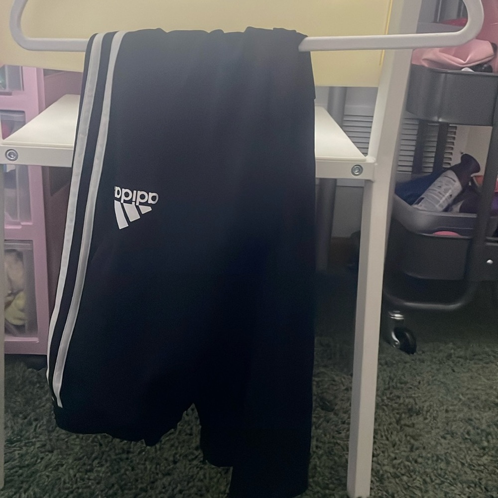 Black Adidas joggers with zipper pockets